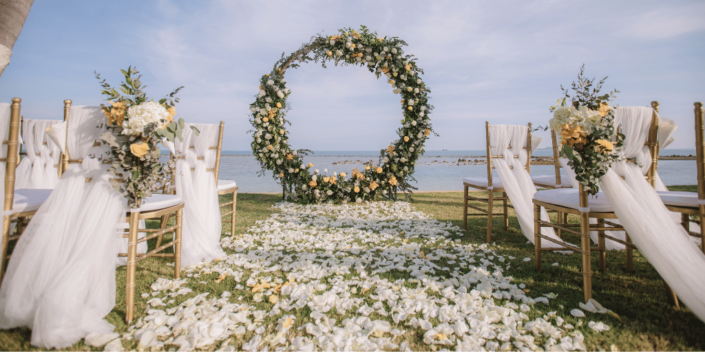 Outdoor destination wedding setup with flowers and scenic backdrop