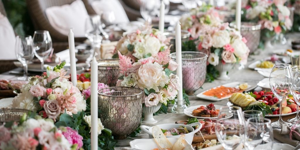 Spring wedding table setup with pastel floral arrangements, soft candles, and delicate glassware.